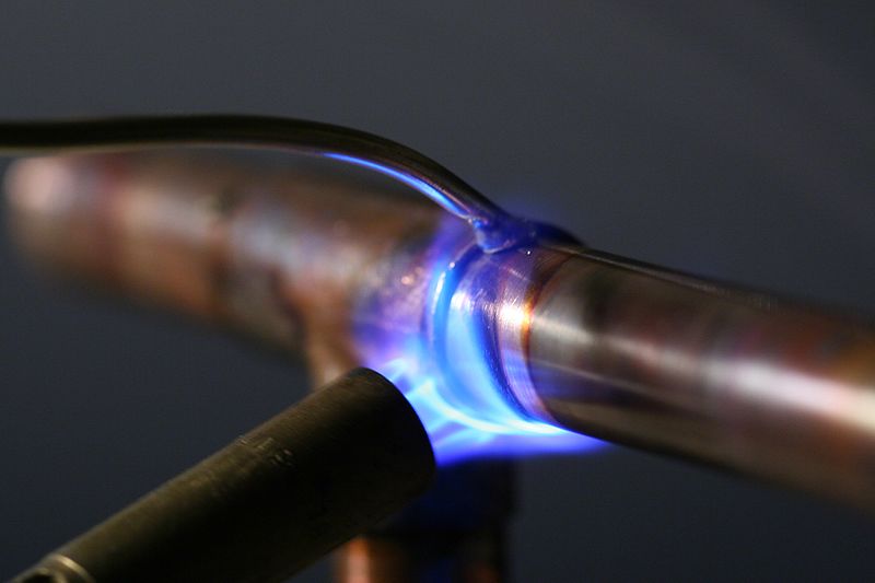using a torch to fuse two pipes